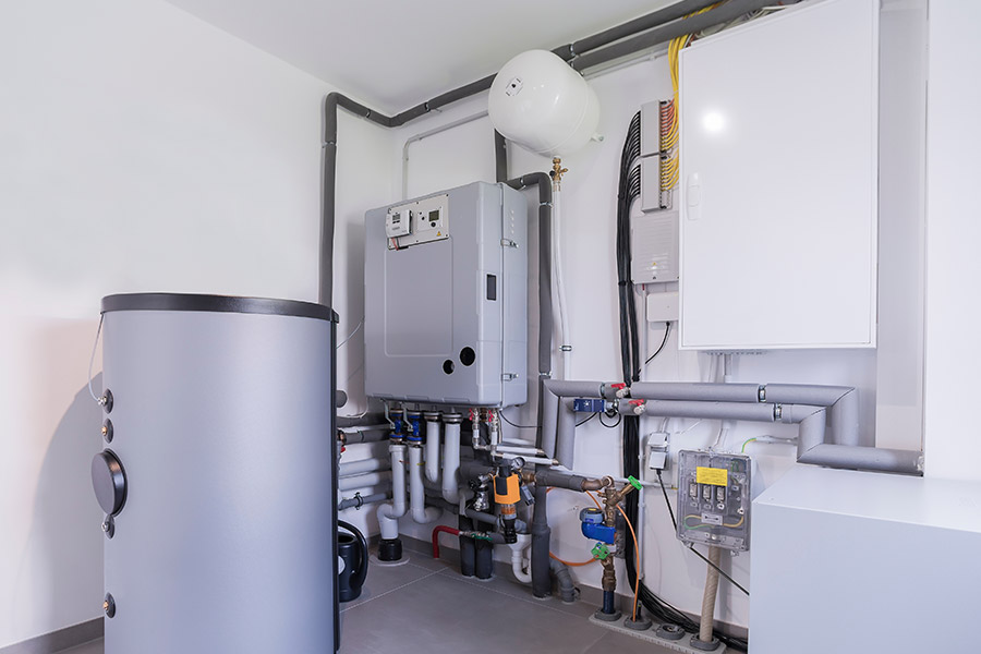 Boiler system with pipes and controls in a utility room