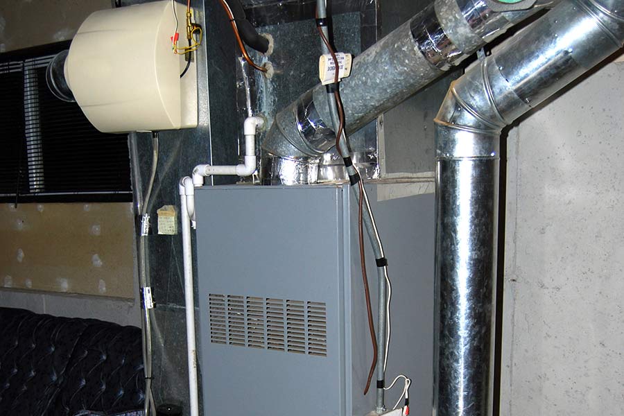 Boiler setup with metallic ducts and piping in a utility area